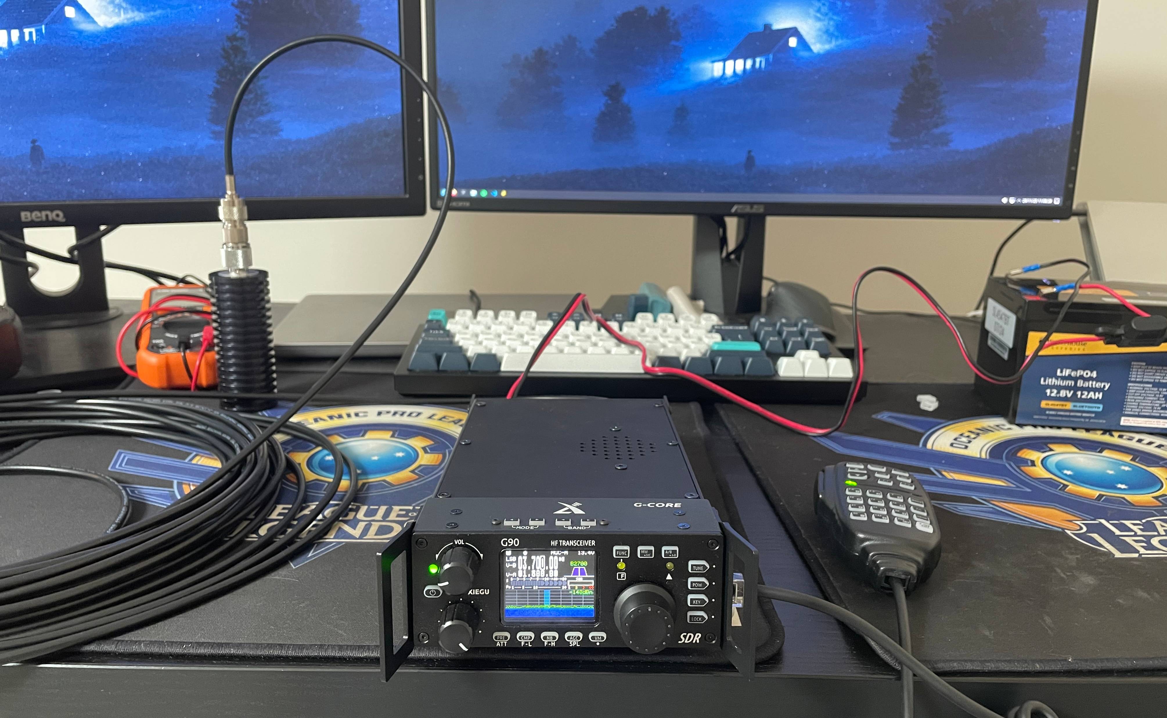 Square plastic antenna box with metal wing nuts drilled into left and right sides, a circular ring eye bolt drilled into the top, and a coaxial connector drilled into the bottom. There are two wires connected to each lug. One wire is badly soldered to the coaxial connector centre pin, and the other is fastened to the coaxial connector shield.