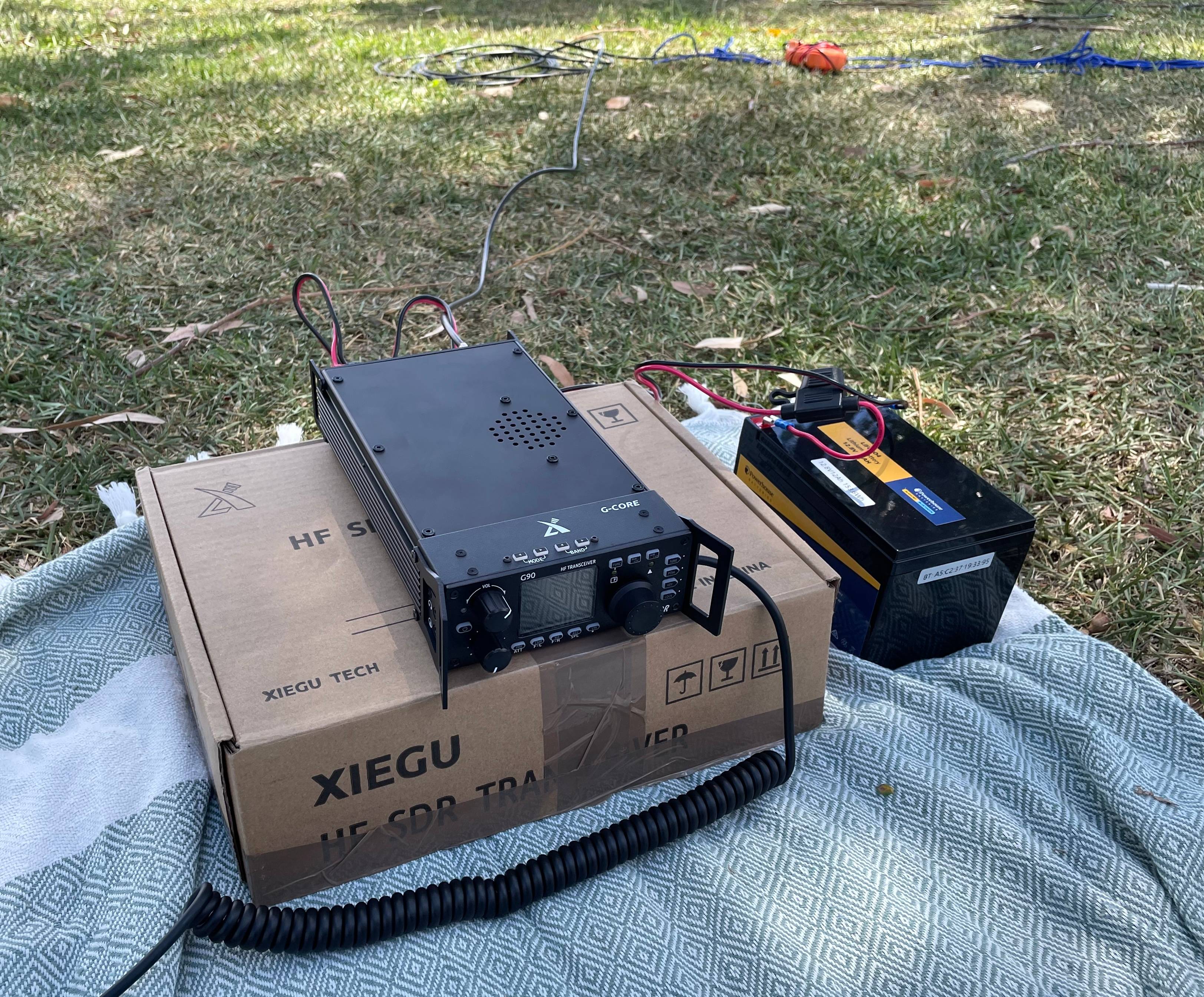Antenna box rigged into a low tree branch, hanging by blue para cord.